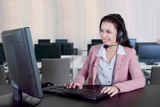 Woman with headset on computer