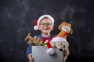 boy holding box of toys